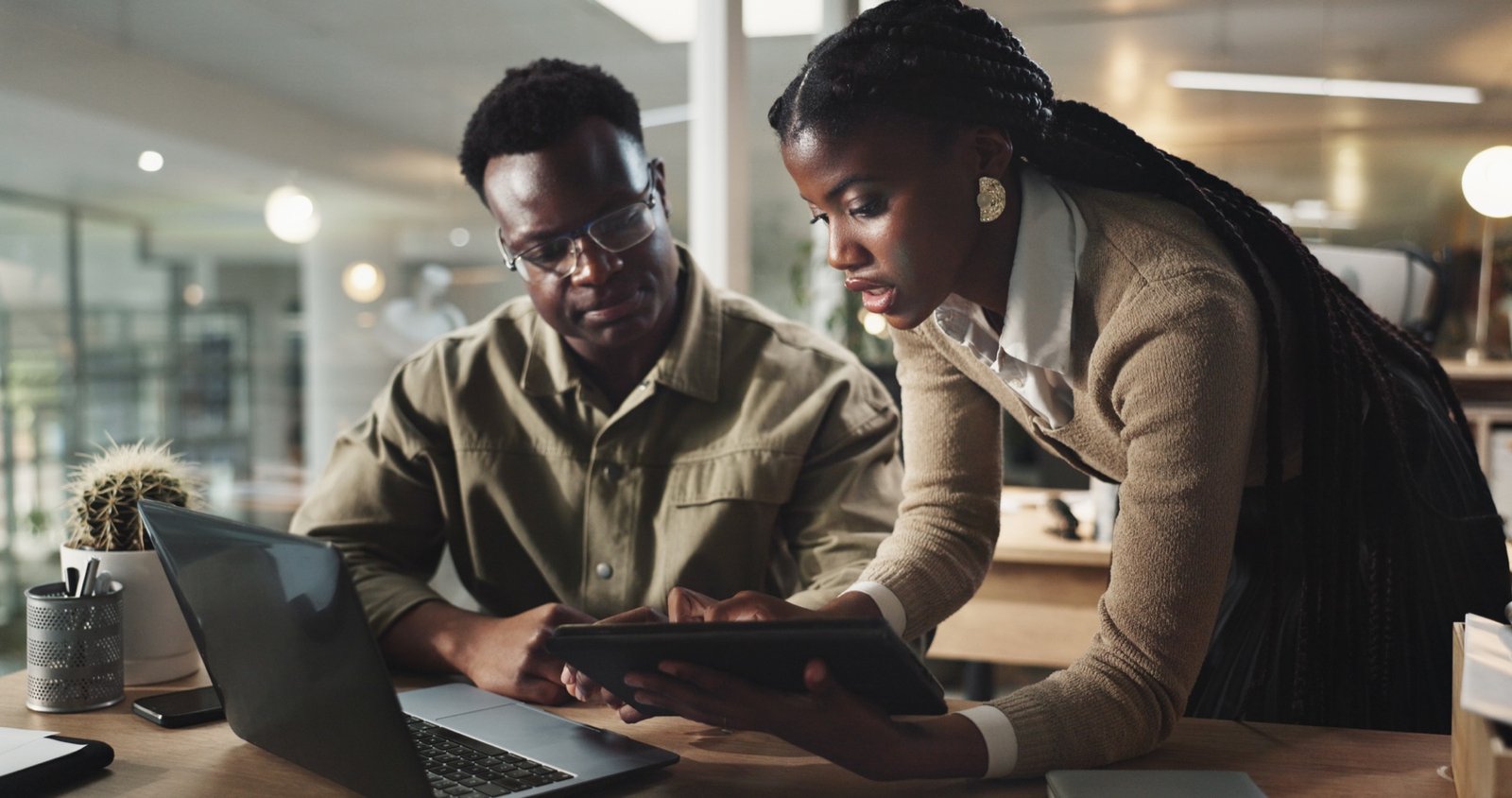African technology professionals collaborating around a digital tablet
