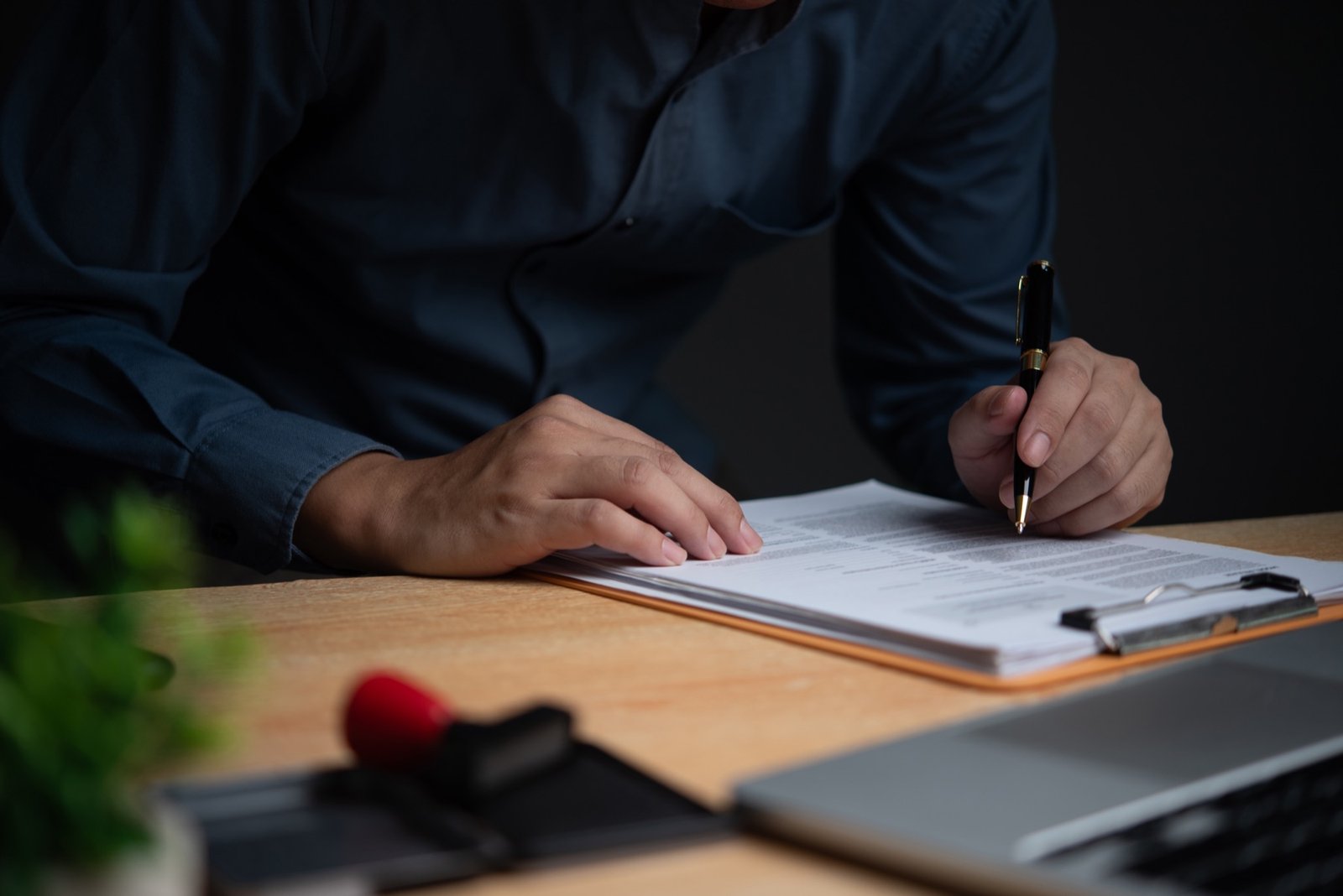 Business professional signing compliance documents